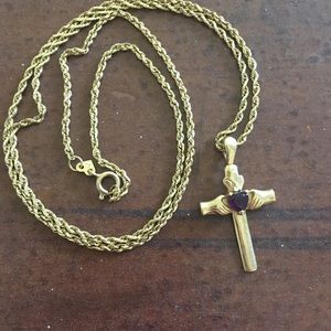 Gold cross with purple stone